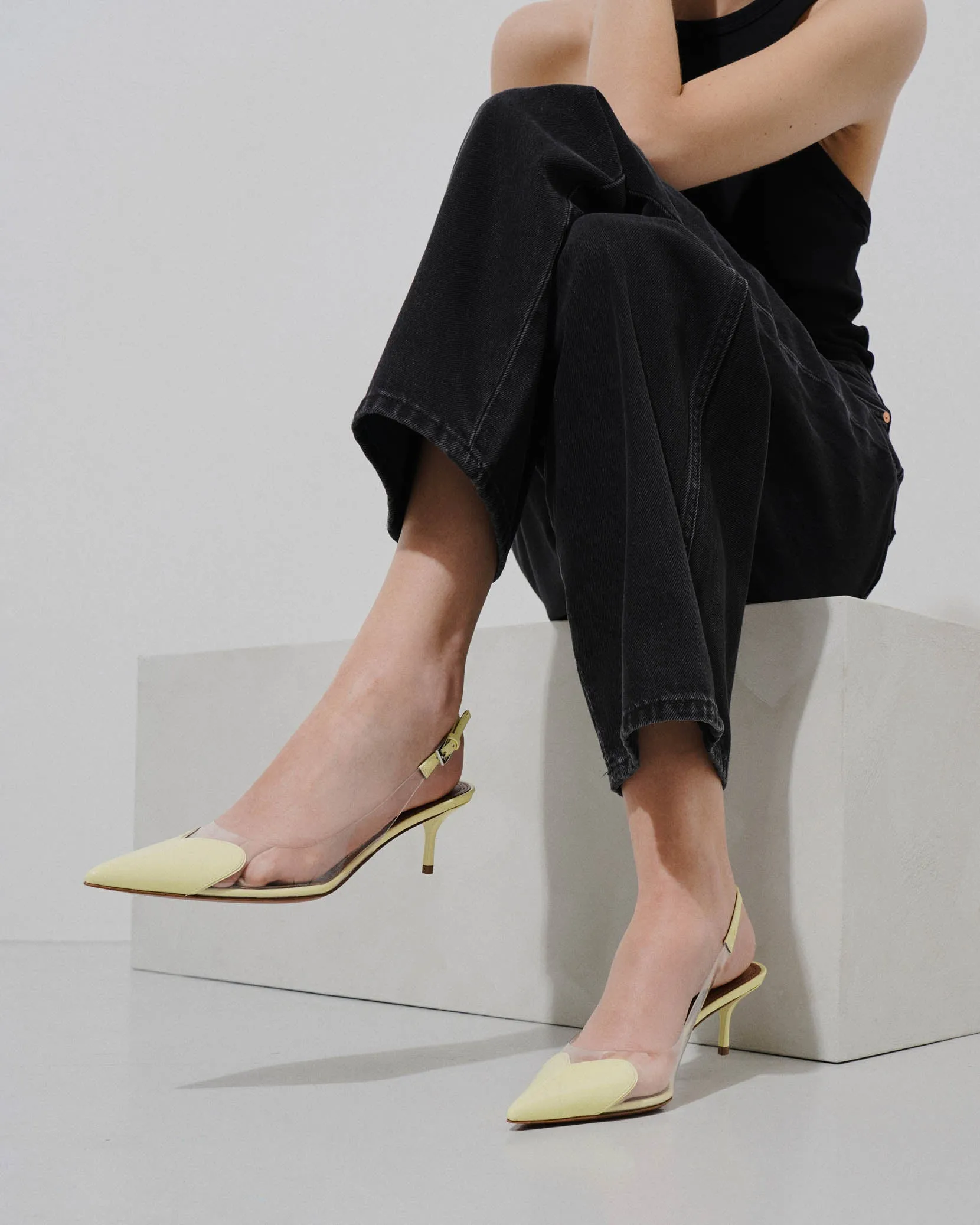 Coeur 55 yellow patent slingback pumps
