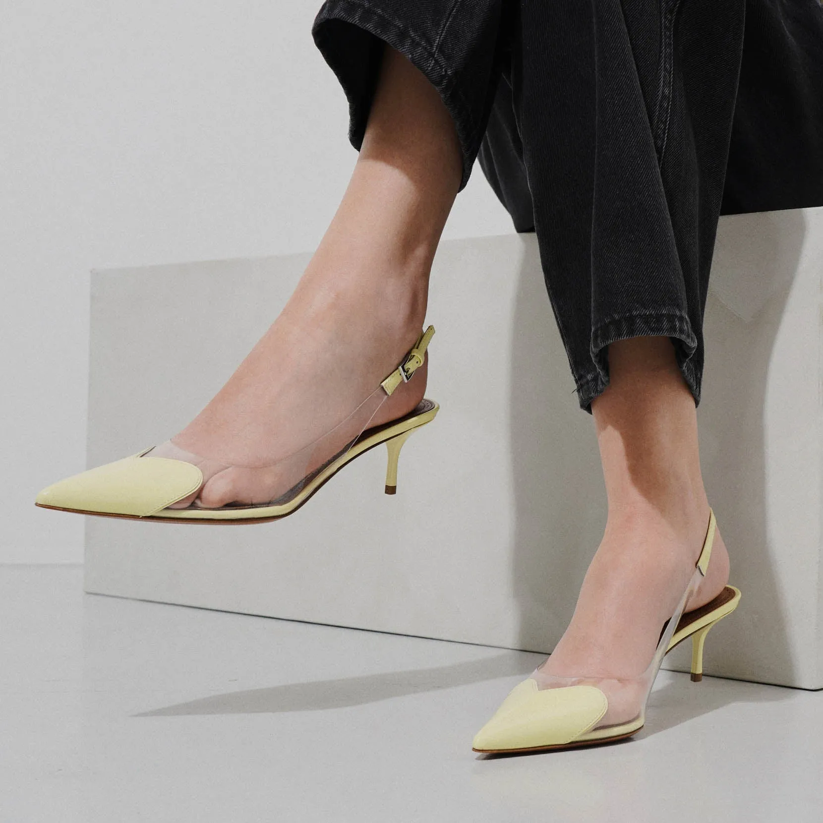 Coeur 55 yellow patent slingback pumps